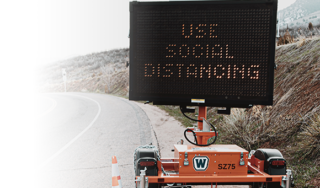 social distancing road sign